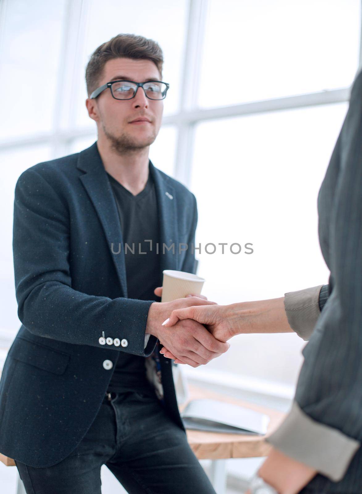 business people greeting each other with a handshake by asdf