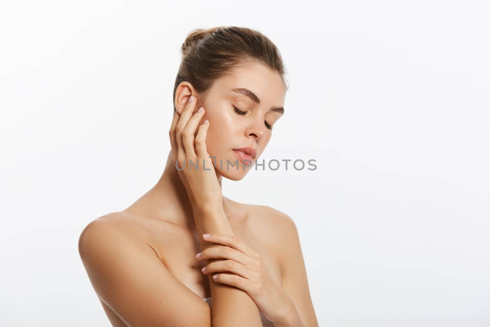 Youth and Skin Care Concept - Beauty Woman face Portrait. Beautiful model Girl with Perfect Fresh Clean Skin. Isolated on white background. by Benzoix