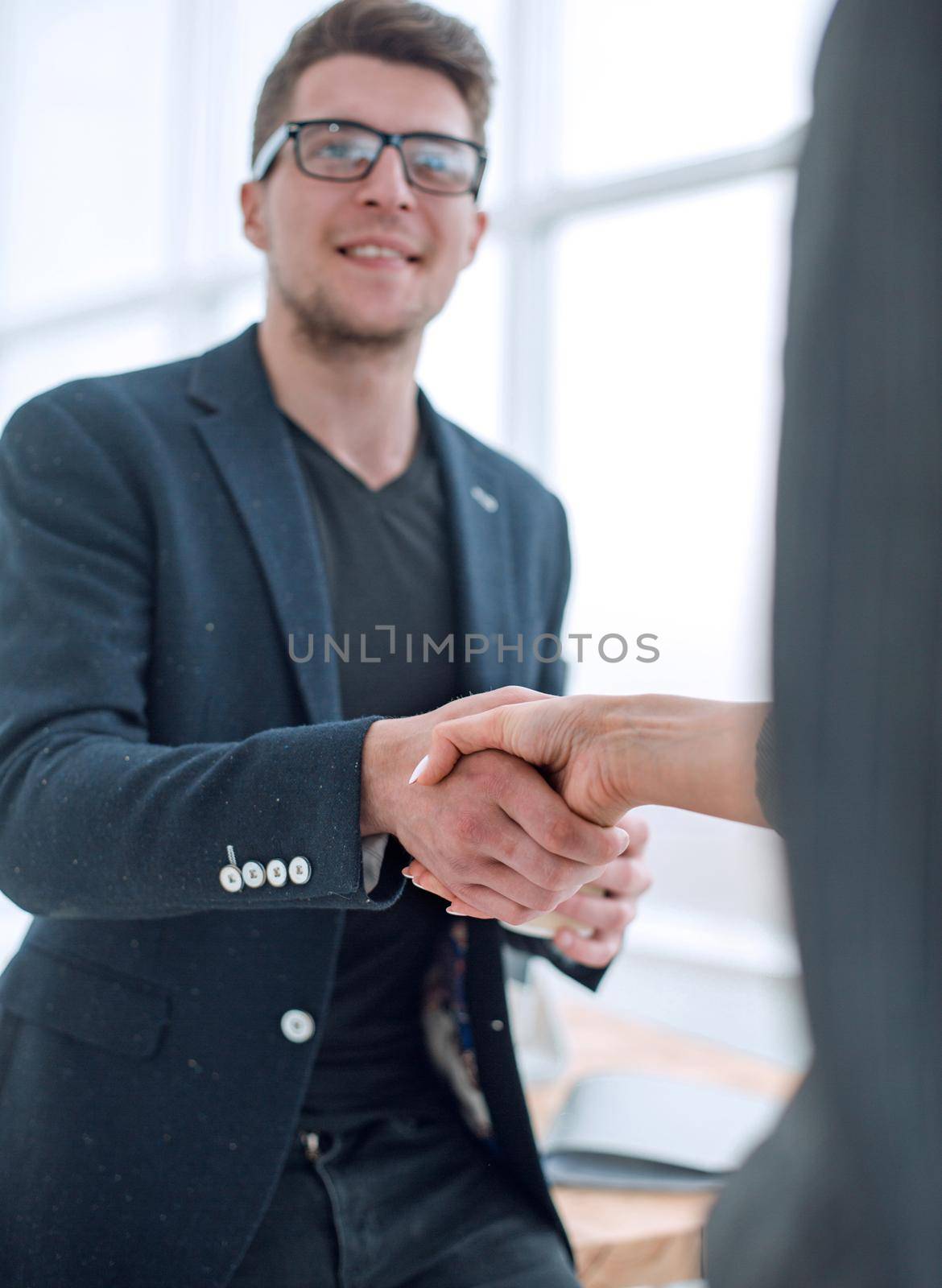business people greeting each other with a handshake by asdf