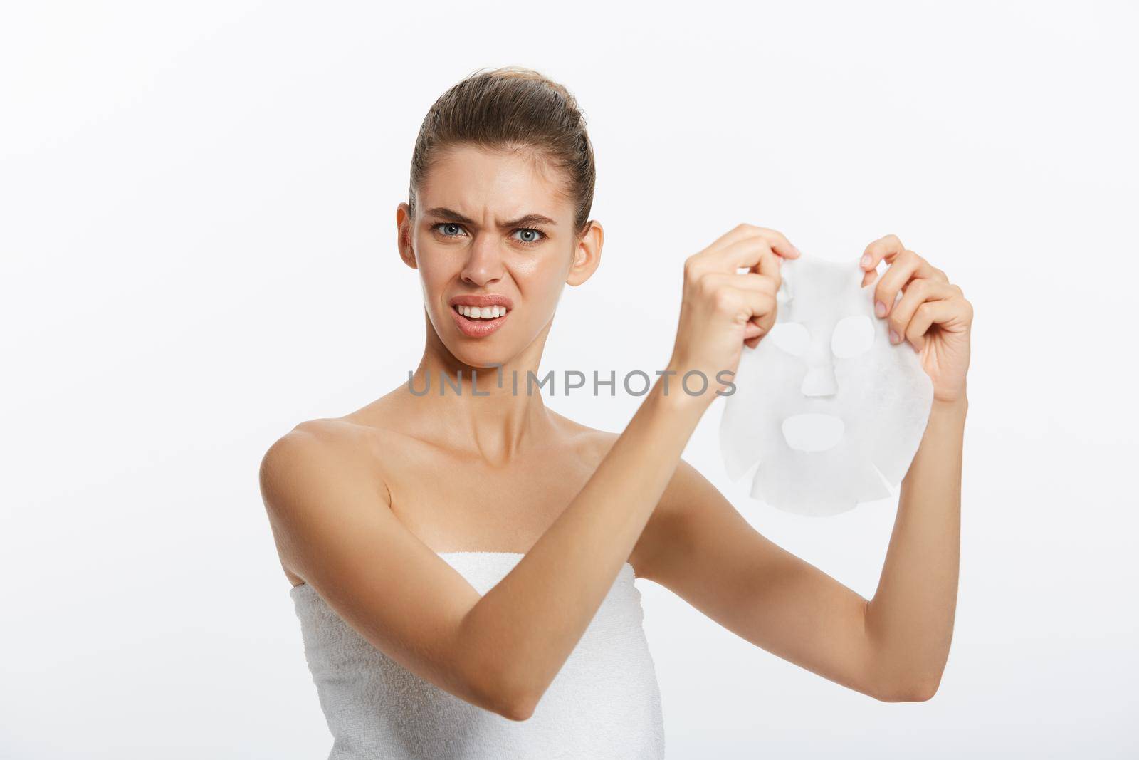 Beautiful woman surprising with facial mask sheet on white background by Benzoix