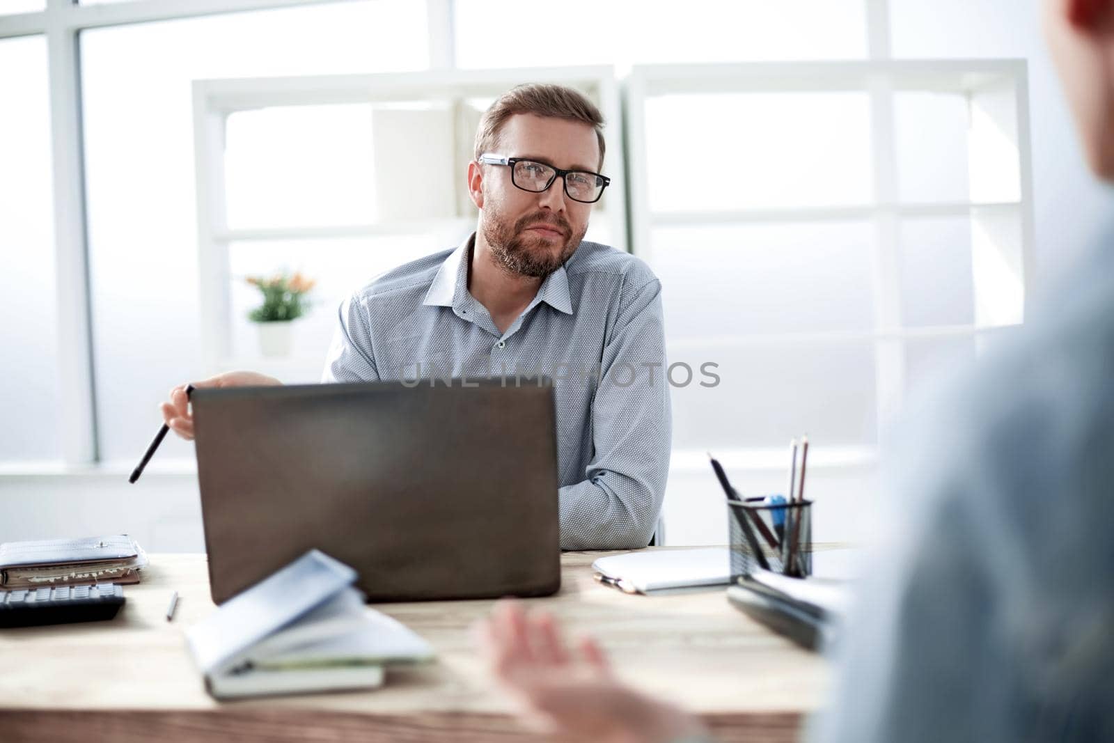 close up. attractive businessman sitting at the office Desk. office weekdays