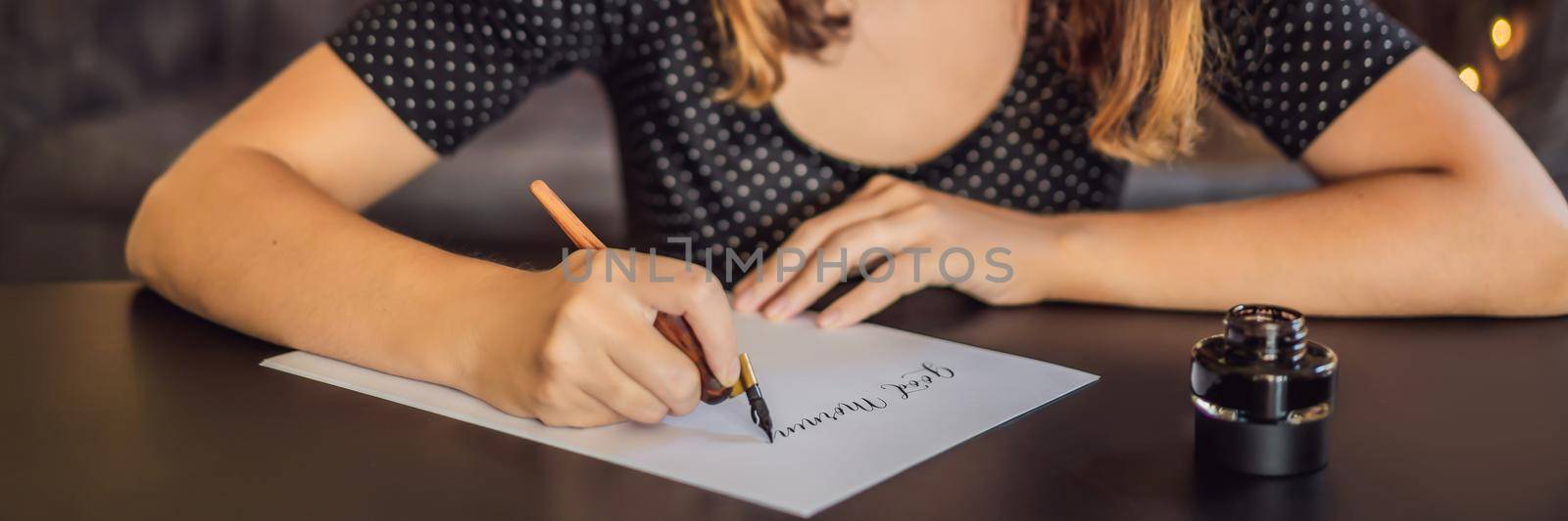 BANNER, LONG FORMAT Good morning. Calligrapher Young Woman writes phrase on white paper. Inscribing ornamental decorated letters. Calligraphy, graphic design, lettering, handwriting, creation concept by galitskaya