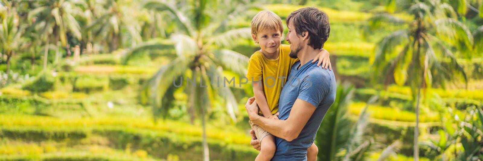 BANNER, LONG FORMAT Dad and son travelers on Beautiful Rice Terraces against the background of famous volcanoes in Bali, Indonesia Traveling with children concept by galitskaya
