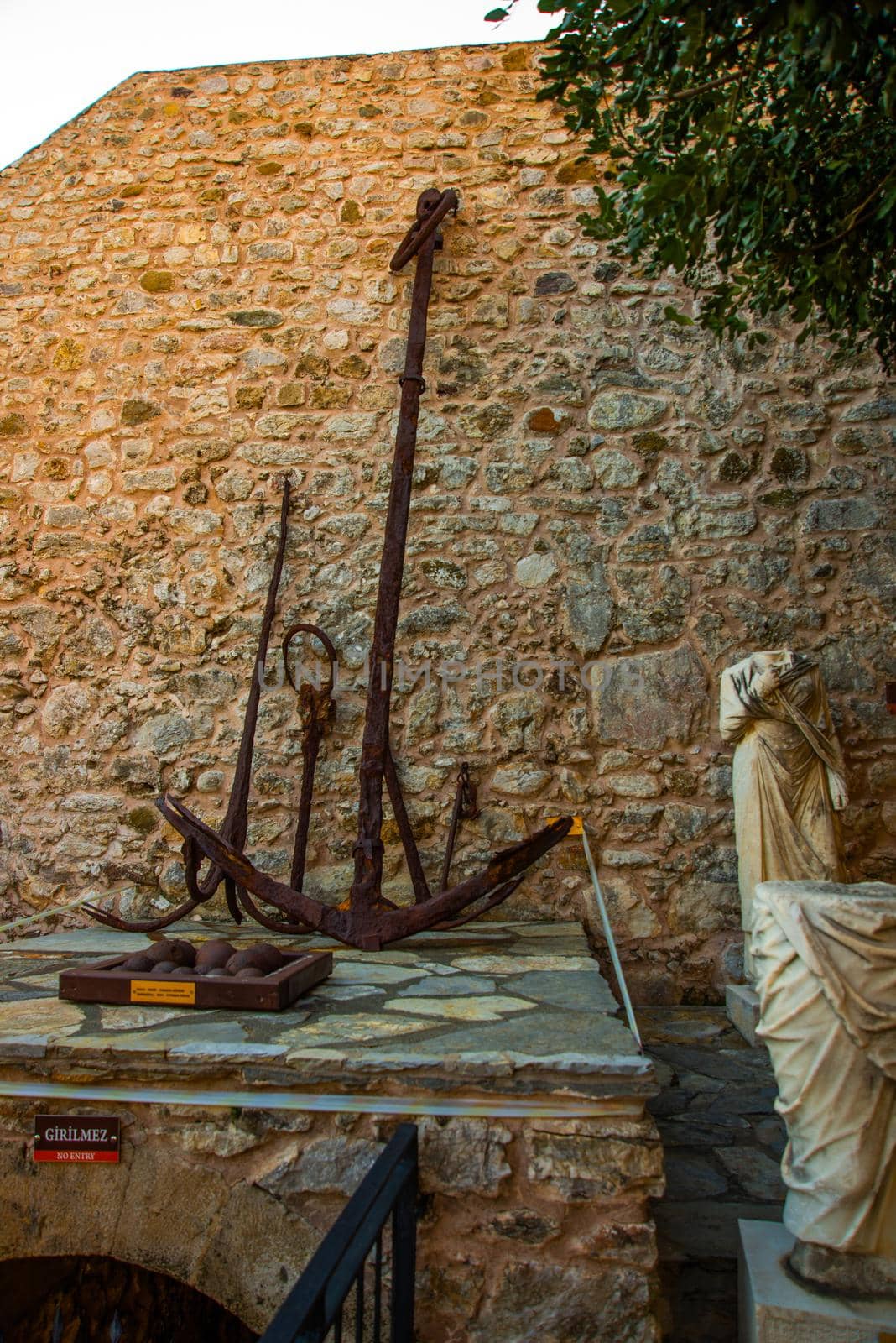 MARMARIS, MUGLA, TURKEY: Antique fragments of sculpture and anchor in the fortress Museum in Marmaris on a sunny day.