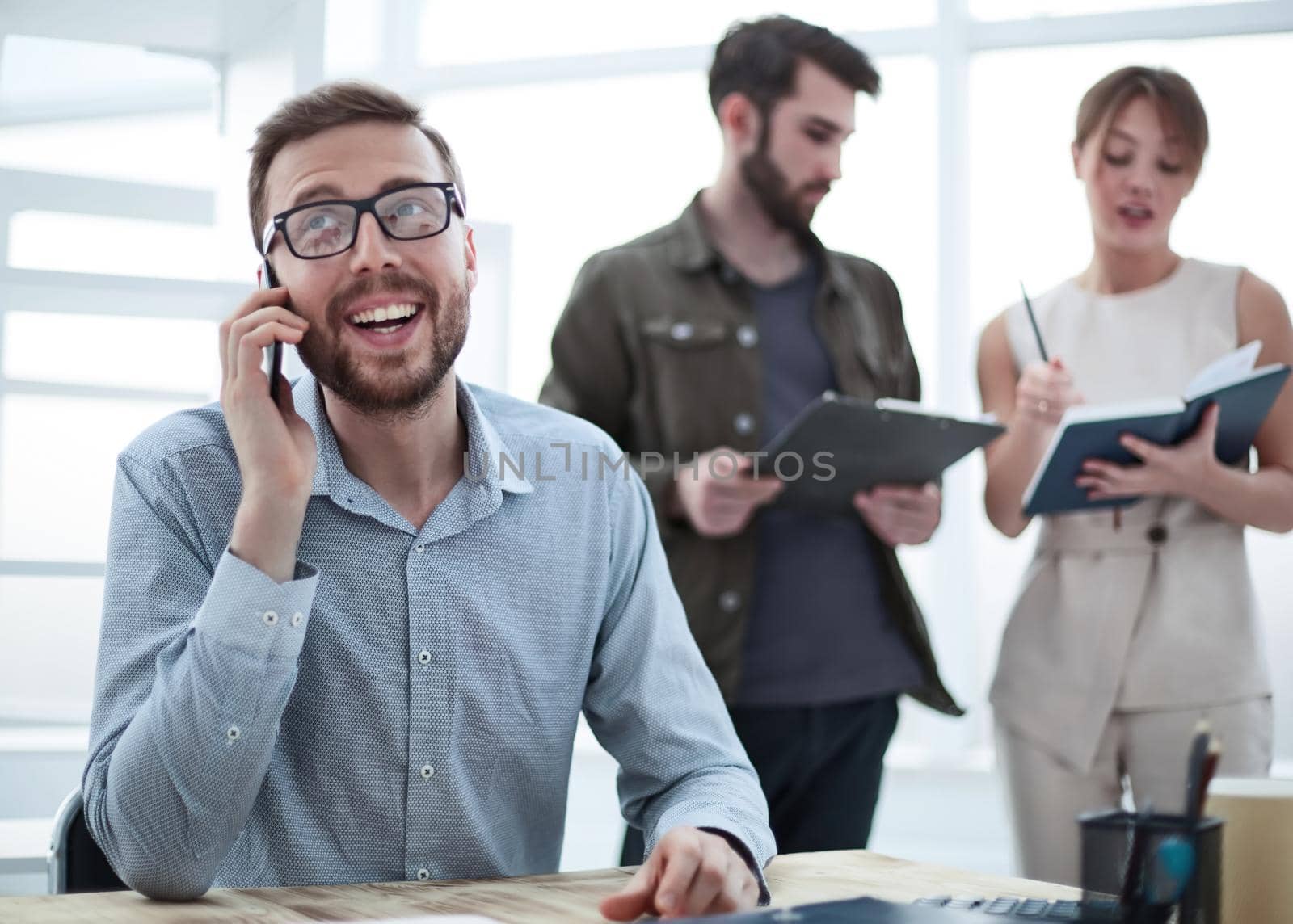 business man talking to a client on a smartphone. people and technology