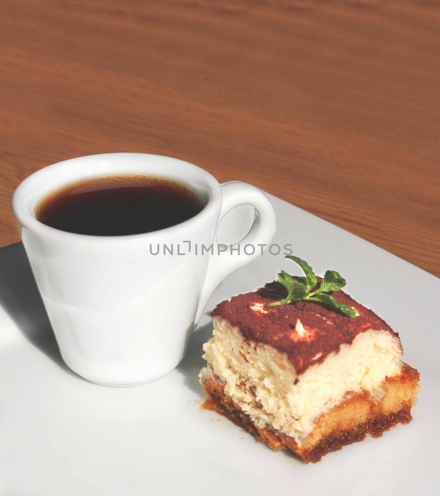 Cup of coffee and piece of cake tiramisu