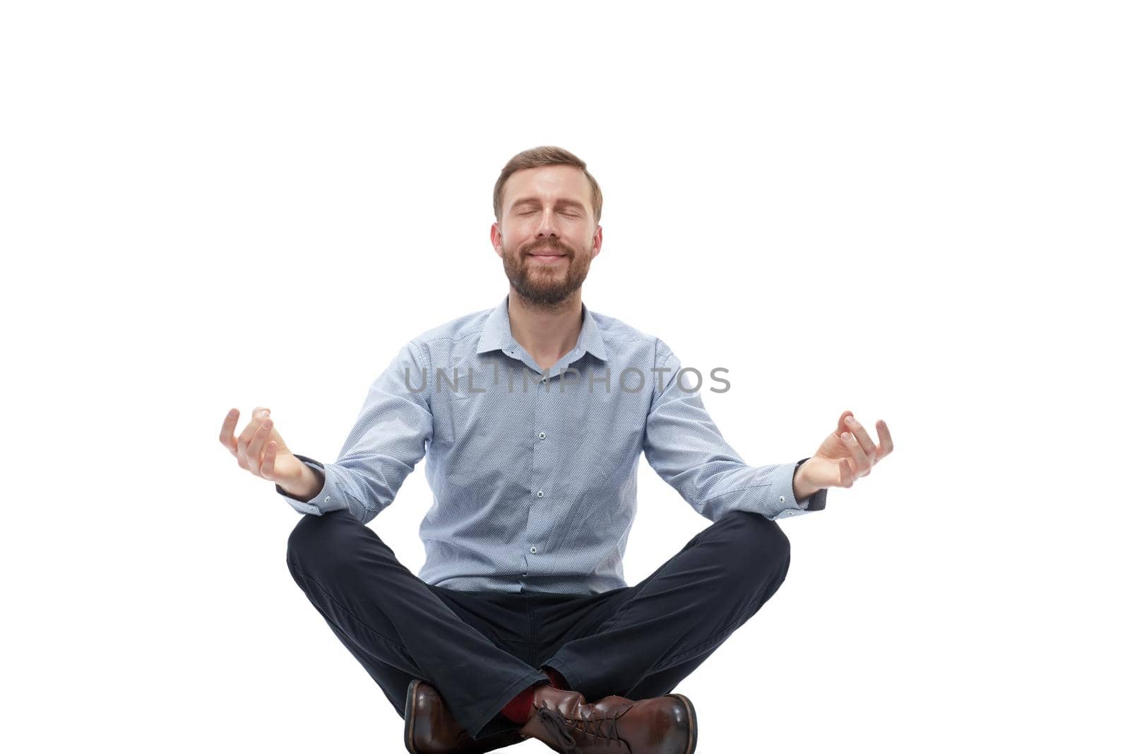 young businessman meditates sitting on the floor by asdf