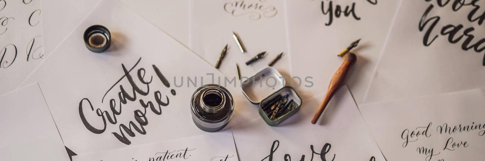 Lettering, calligraphy, writes phrase on white paper. Inscribing ornamental decorated letters. Calligraphy, graphic design, lettering, handwriting creation concept BANNER, LONG FORMAT