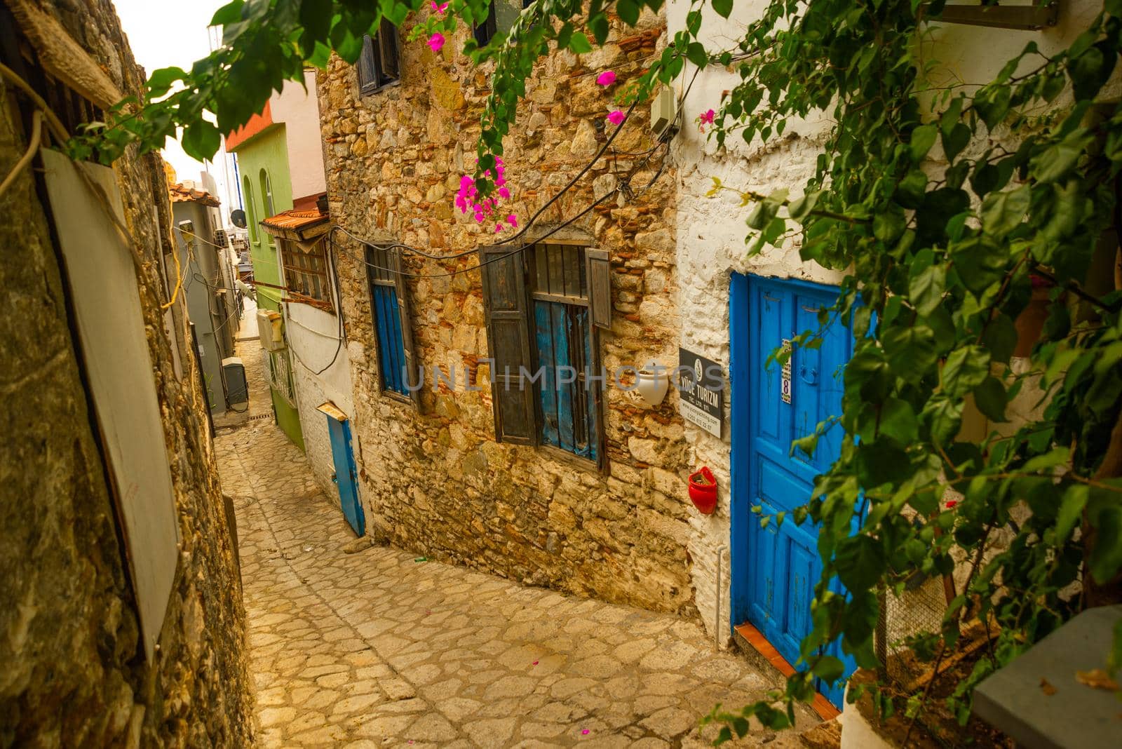 MARMARIS, MUGLA, TURKEY: Ornate street with old houses in the historical center in Marmaris. Narrow streets with stairs among the houses with white brick, green plants and flowers.
