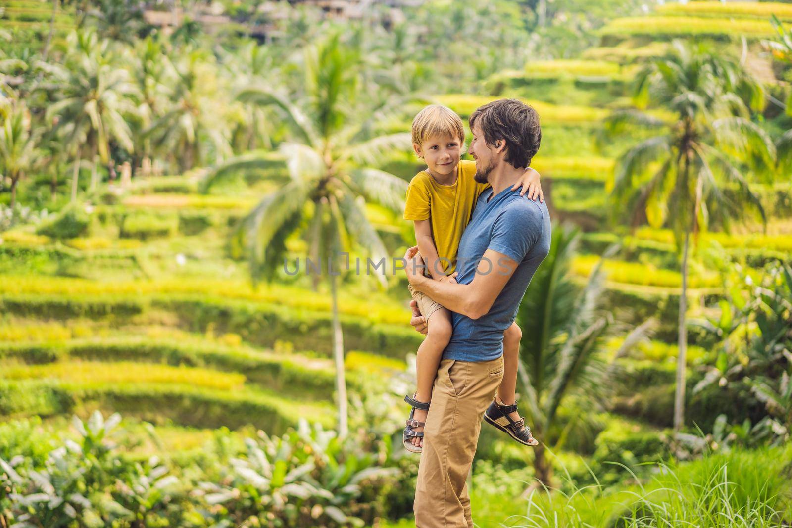 Dad and son travelers on Beautiful Rice Terraces against the background of famous volcanoes in Bali, Indonesia Traveling with children concept by galitskaya