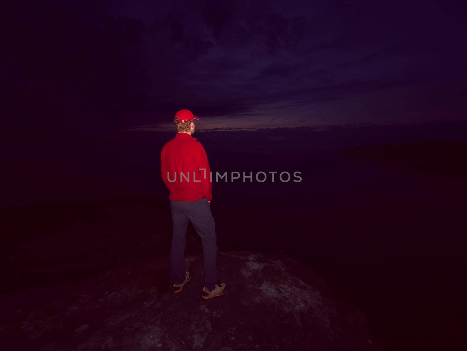 Man lost in thick mist rocks. Hiker climbed up alone to exposed summit by rdonar2