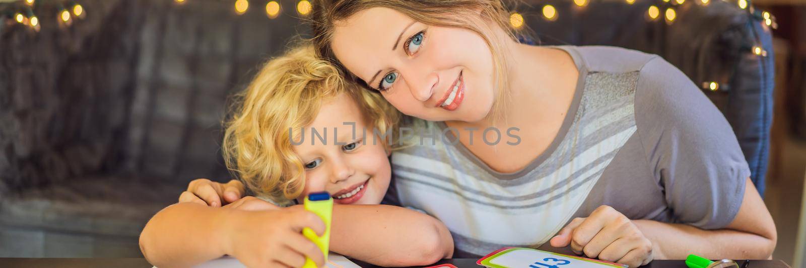A teacher, a tutor for home schooling and a teacher at the table. Or mom and daughter. Homeschooling. BANNER, LONG FORMAT