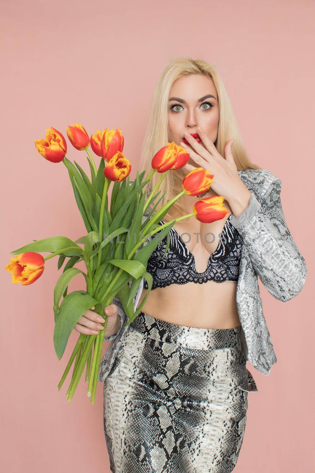 Blonde woman in snake suit holding bouquet tulips by Bonda