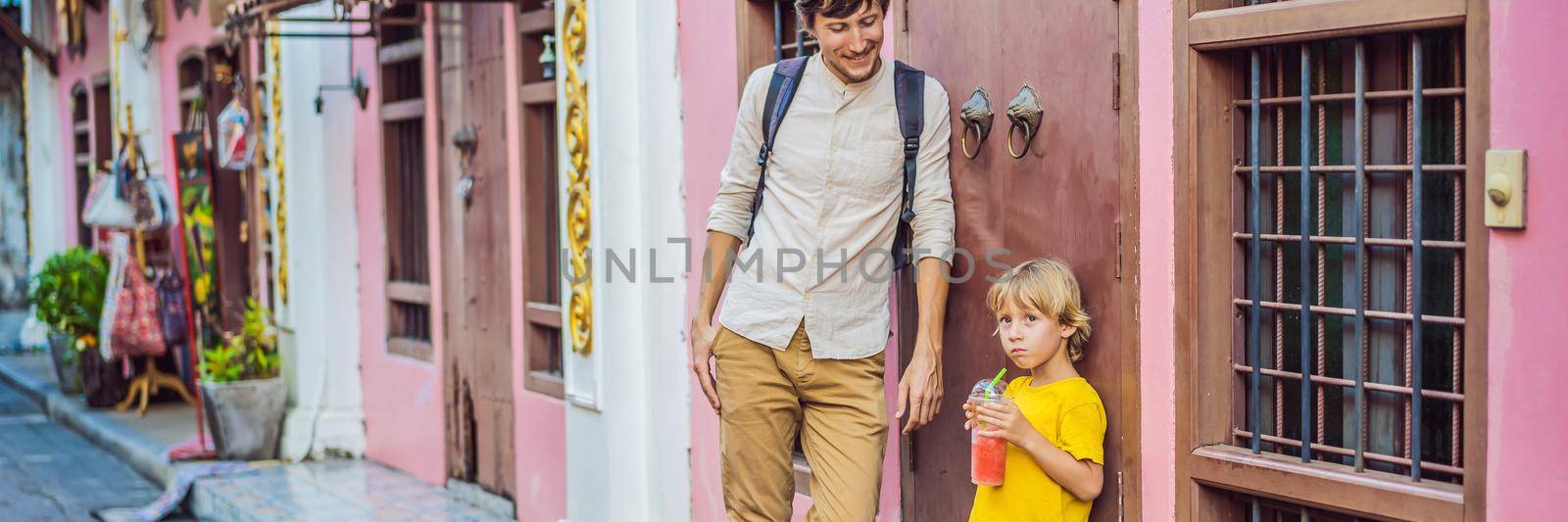 BANNER, LONG FORMAT Dad and son tourists on the Street in the Portugese style Romani in Phuket Town. Also called Chinatown or the old town. Traveling with kids concept.