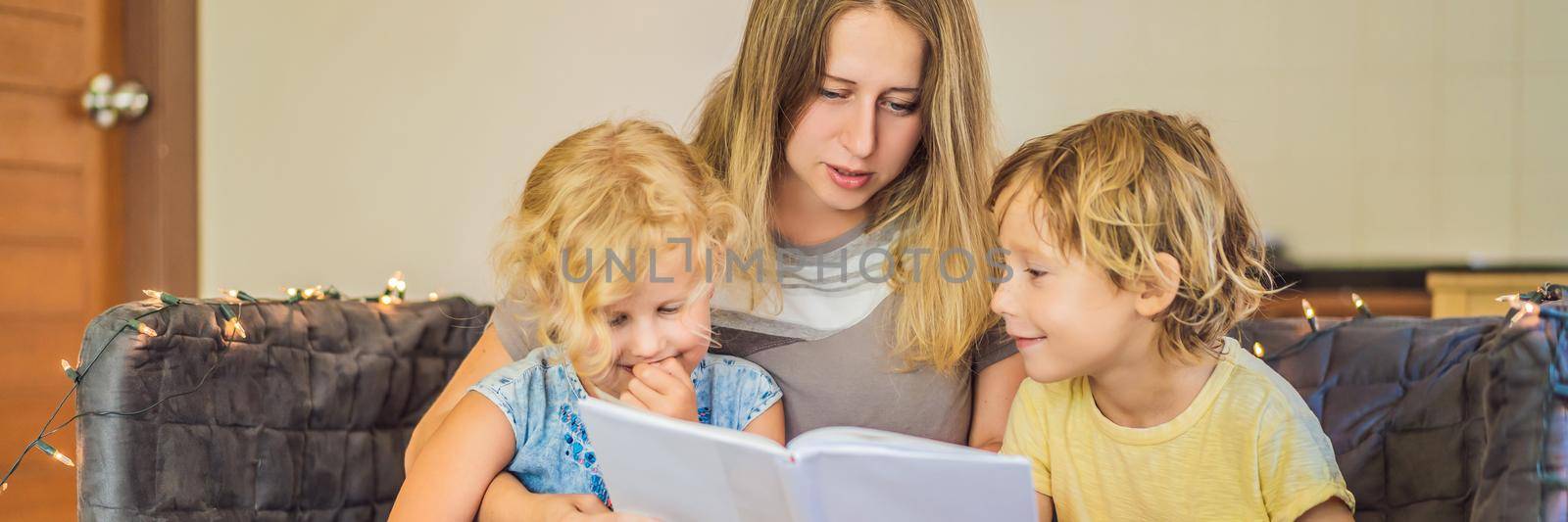 Teacher, tutor for home schooling Boy and girl at the table. Or mother, daughter and son. Homeschooling. BANNER, LONG FORMAT