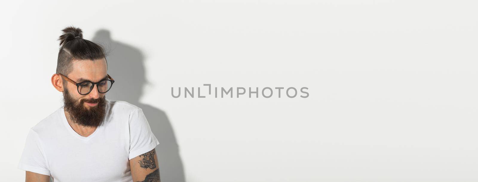 Beauty, fashion and people concept - portrait of hipster man with beard over white background banner with copy space and place for advertising by Satura86