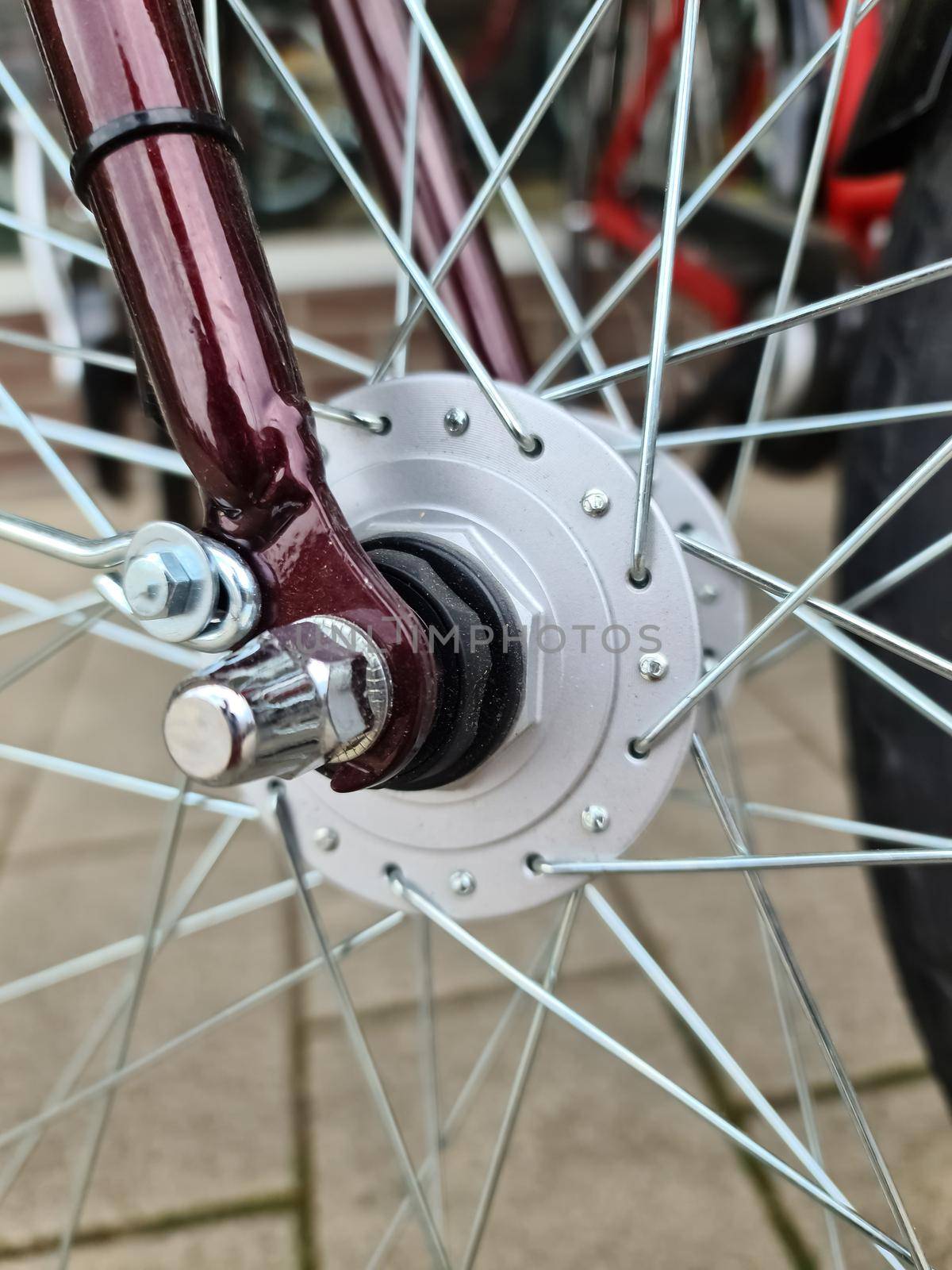 Selective focus close up on a bicycle wheel with metal spokes