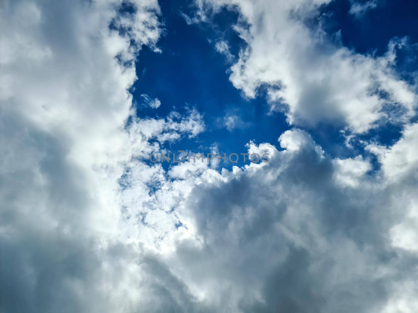 Beautiful fluffy white cloud formations in a deep blue summer sky. by MP_foto71
