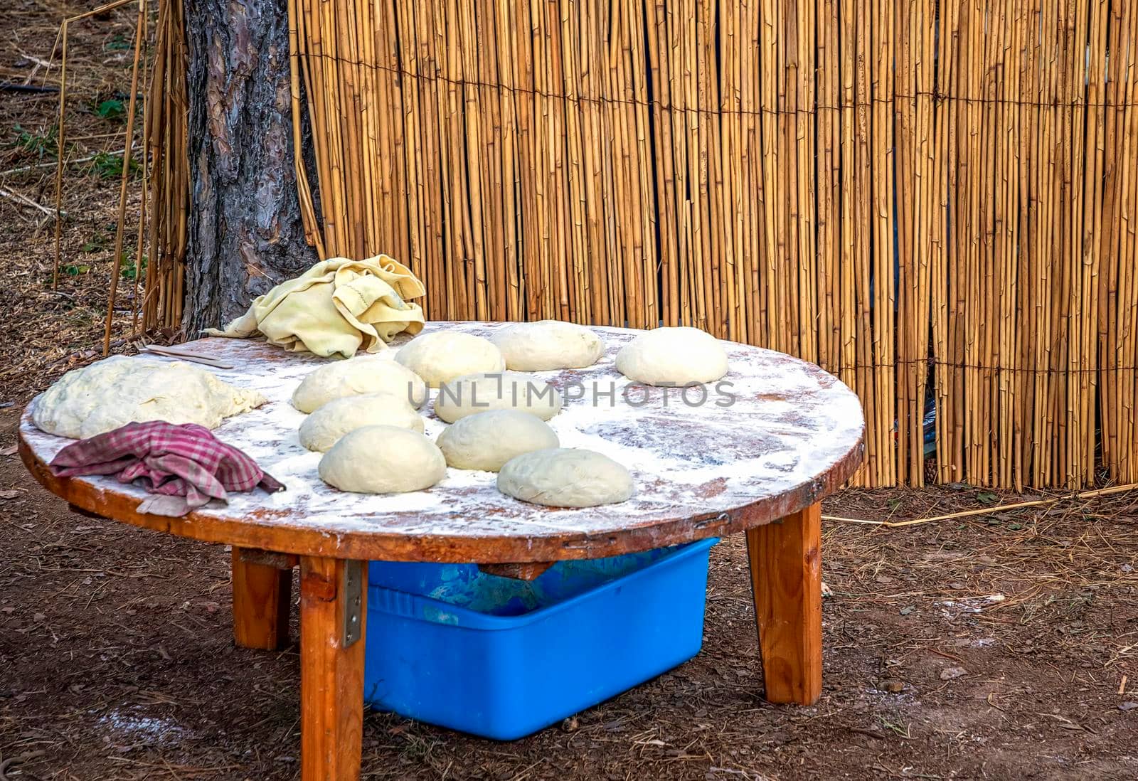 Unbaked bread dough on the table. Sourdough bread buns ready to be baked. Outside 