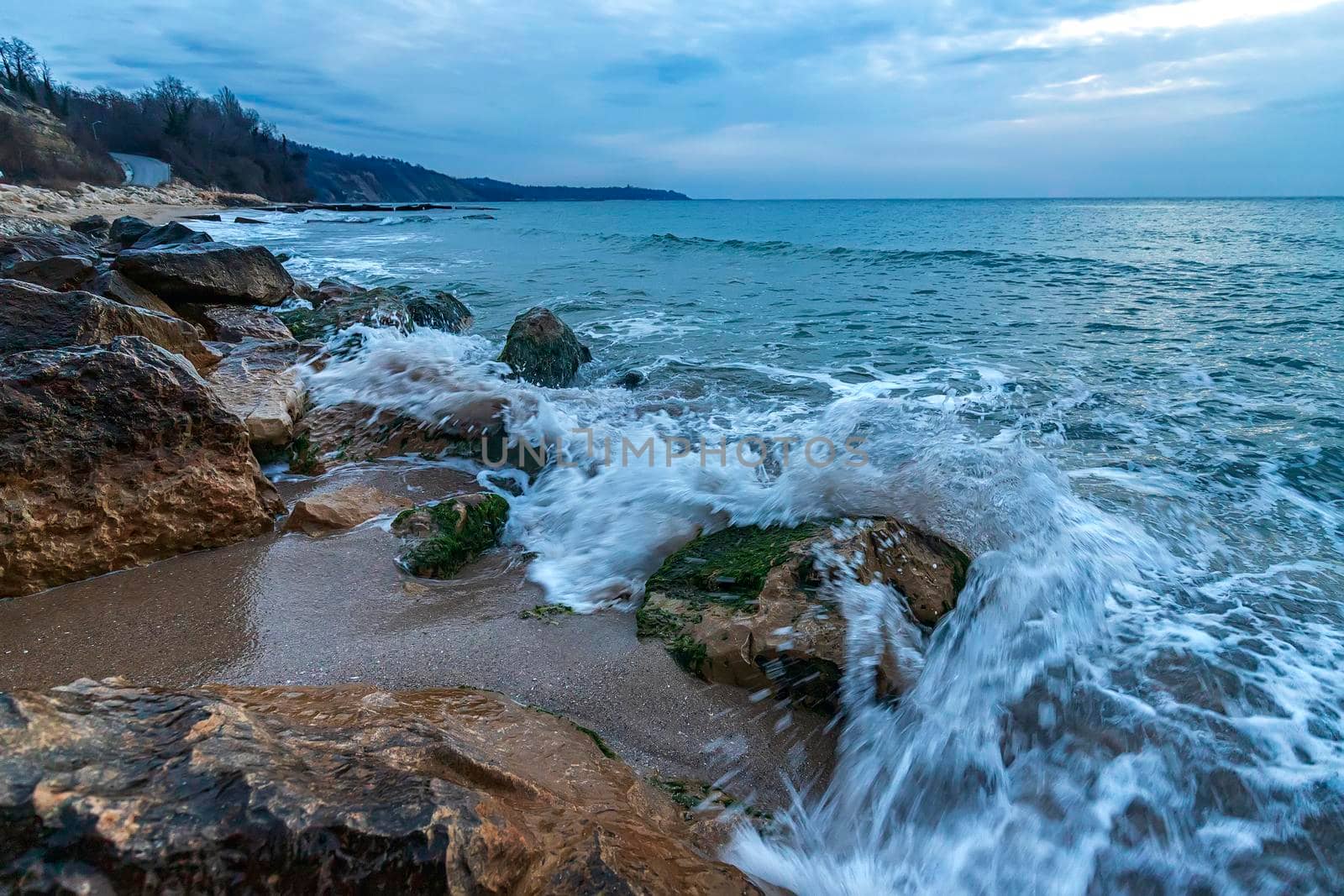 Beautiful motion blur sea waves over the rocks and splash of seawater at morning on the shore of the Black Sea.  by EdVal