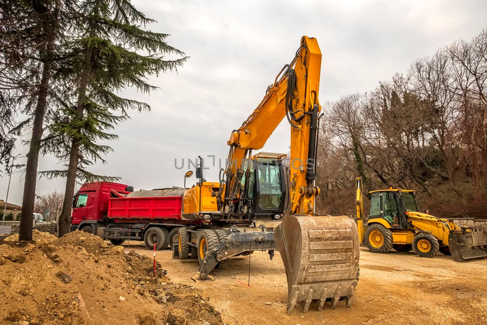 Heavy construction equipment working at the construction site. by EdVal