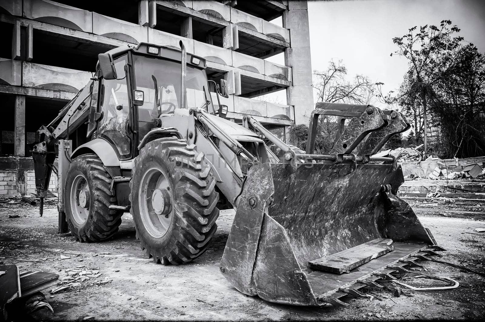 Black and white vintage view of excavator with shovel after work in construction site