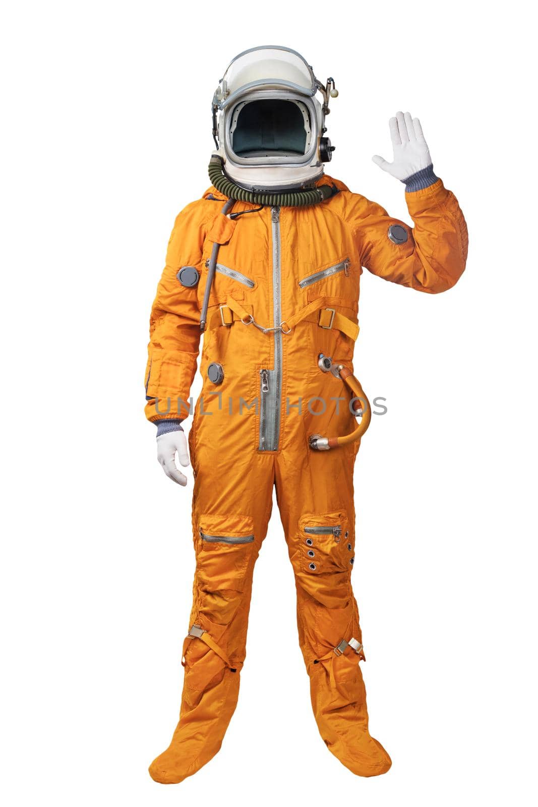 Astronaut wearing an orange spacesuit and helmet waives hand in hello gesture isolated over white background. Astronaut gesturing Hi greeting by dmitryz