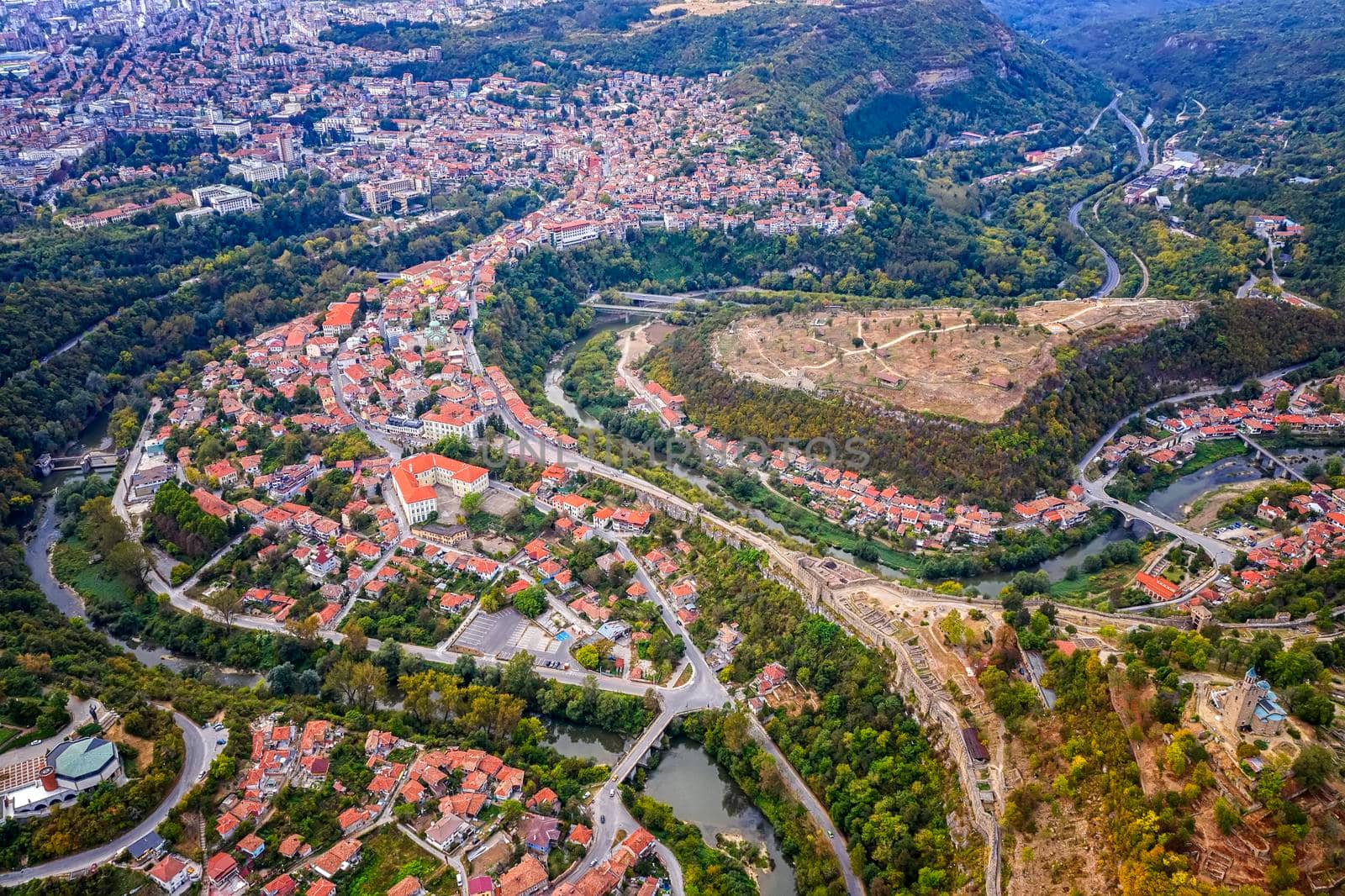 Aerial view from drone of the city and curves of river Yantra, Veliko Tarnovo, Bulgaria by EdVal