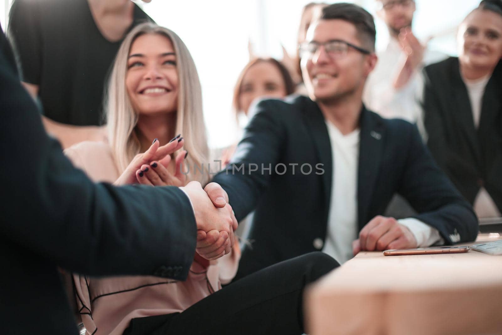 close up. business people shaking hands near the office Desk. concept of partnership