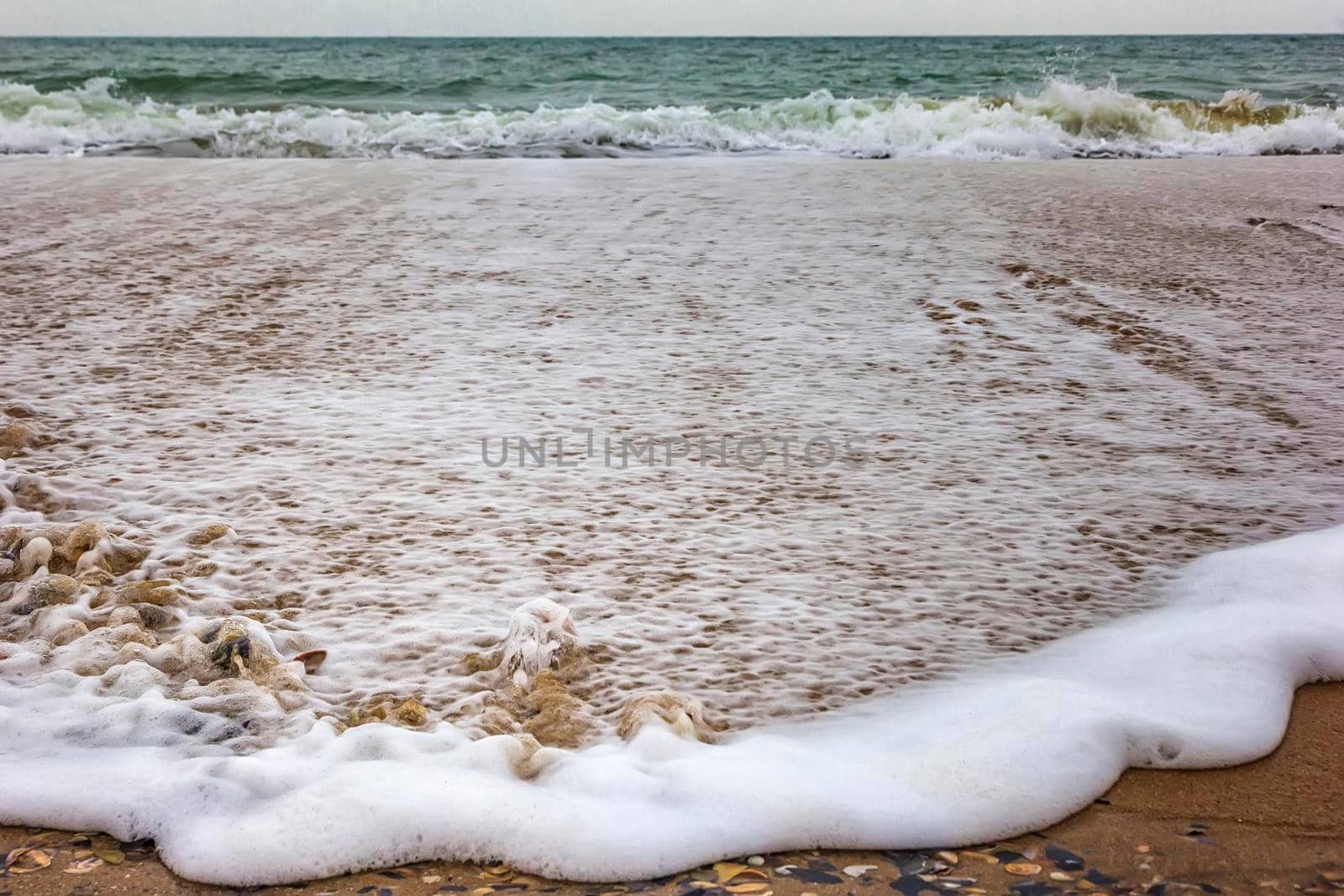 Front view of spilling sea wave with foam. Close up by EdVal