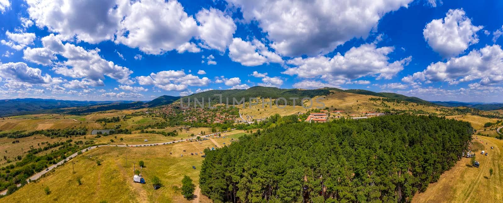 Beautiful aerial panorama of mountain village at hills and beautiful clouds