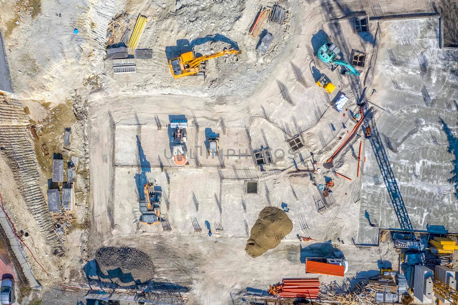 Construction equipment working at the construction site. Aerial view from drone by EdVal