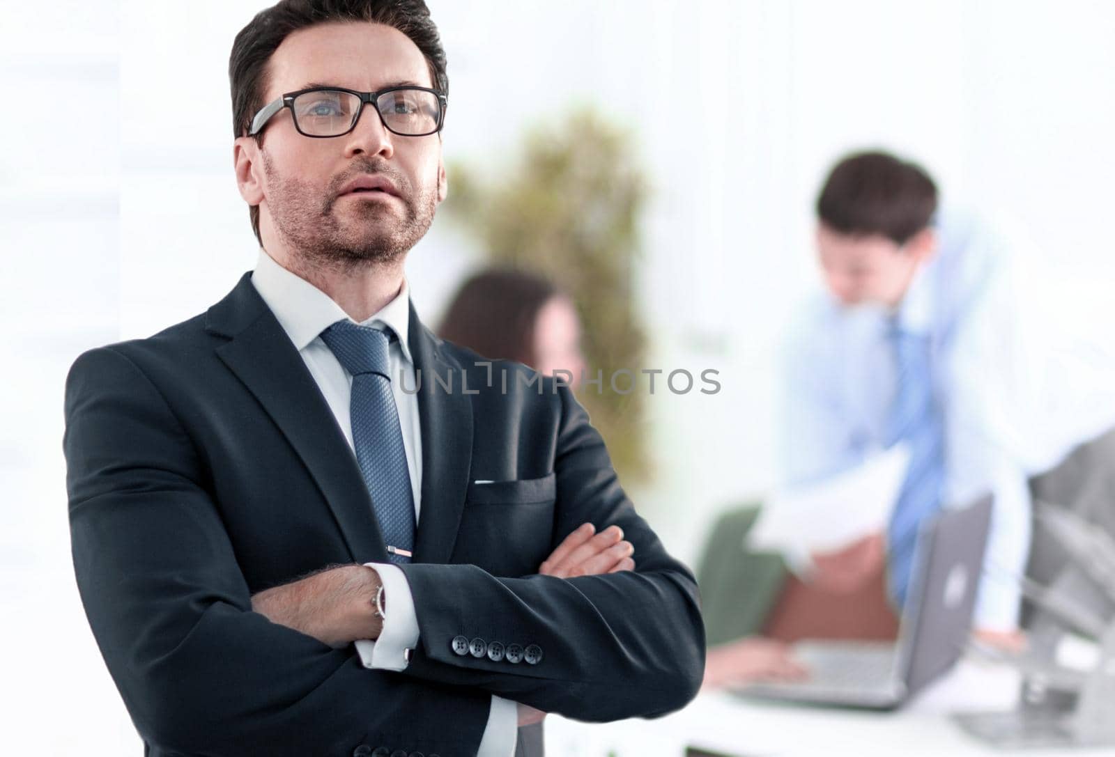 Businessman standing near the window and looking into it.photo with copy space