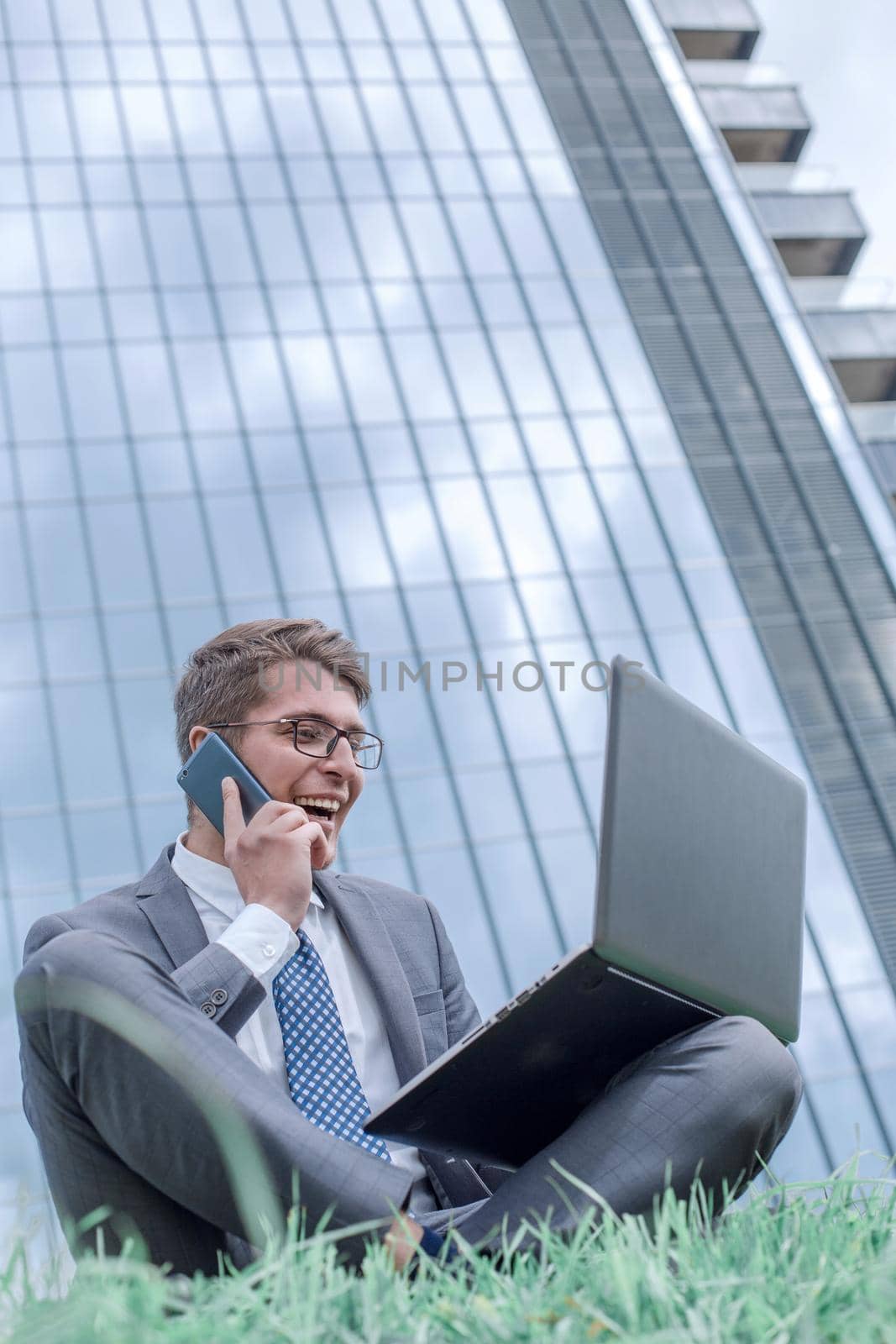 cheerful businessman discussing information on his smartphone . photo with copy space