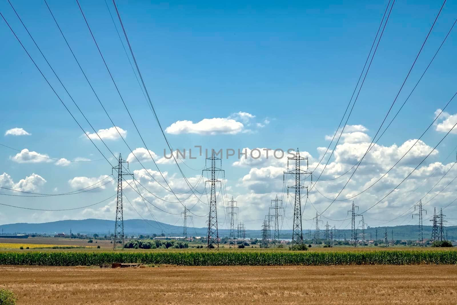 Rows of electrical towers and power lines. Horizontal view