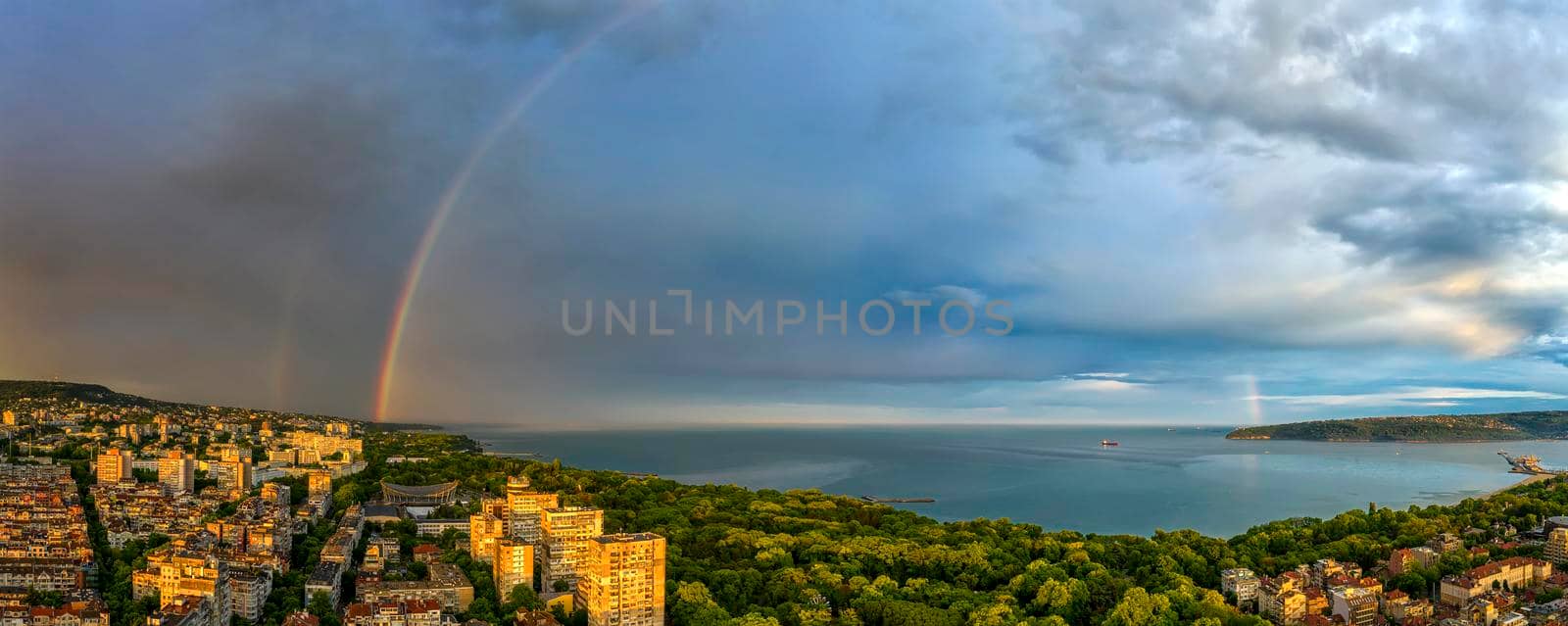 Stunning panorama of a  big rainbow over the sea and coast after the rain 