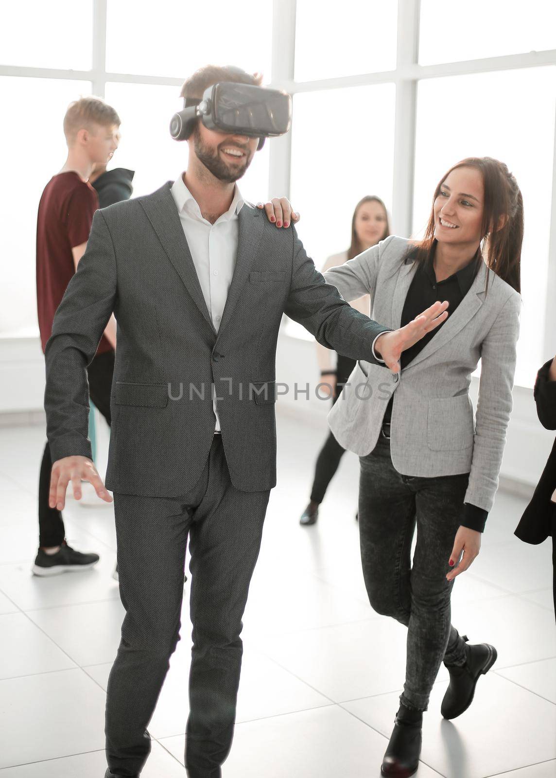 smiling young man in a virtual reality helmet. people and technology