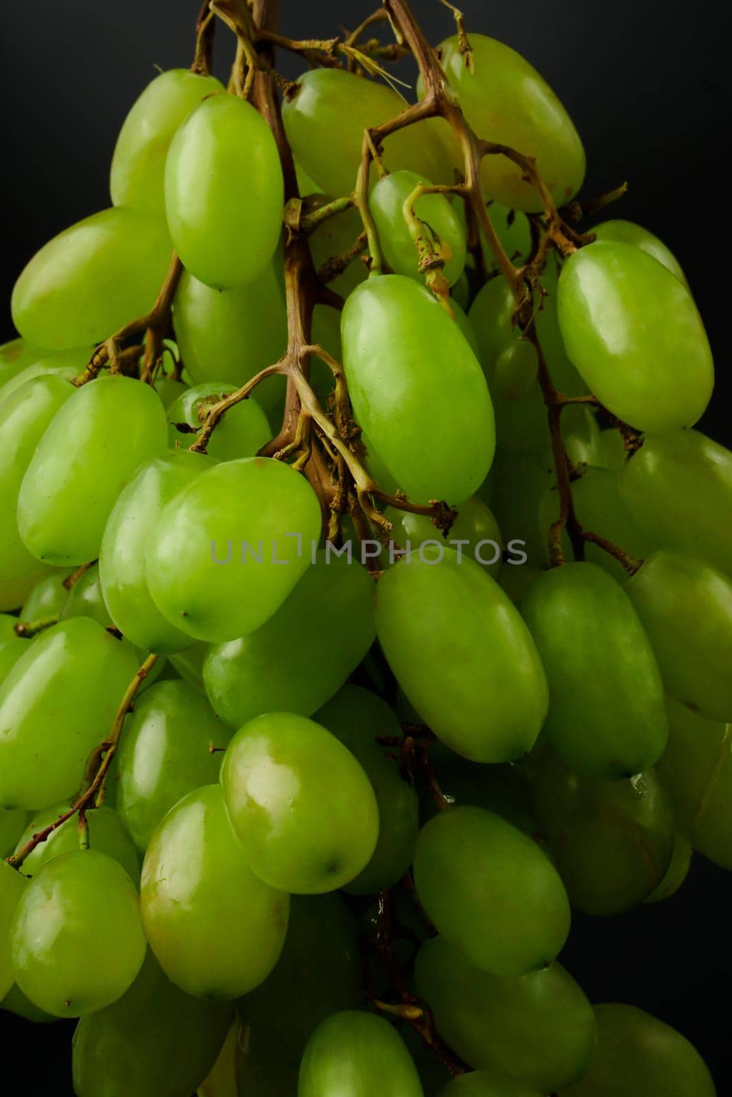 A bunch of table grapes, on a black background