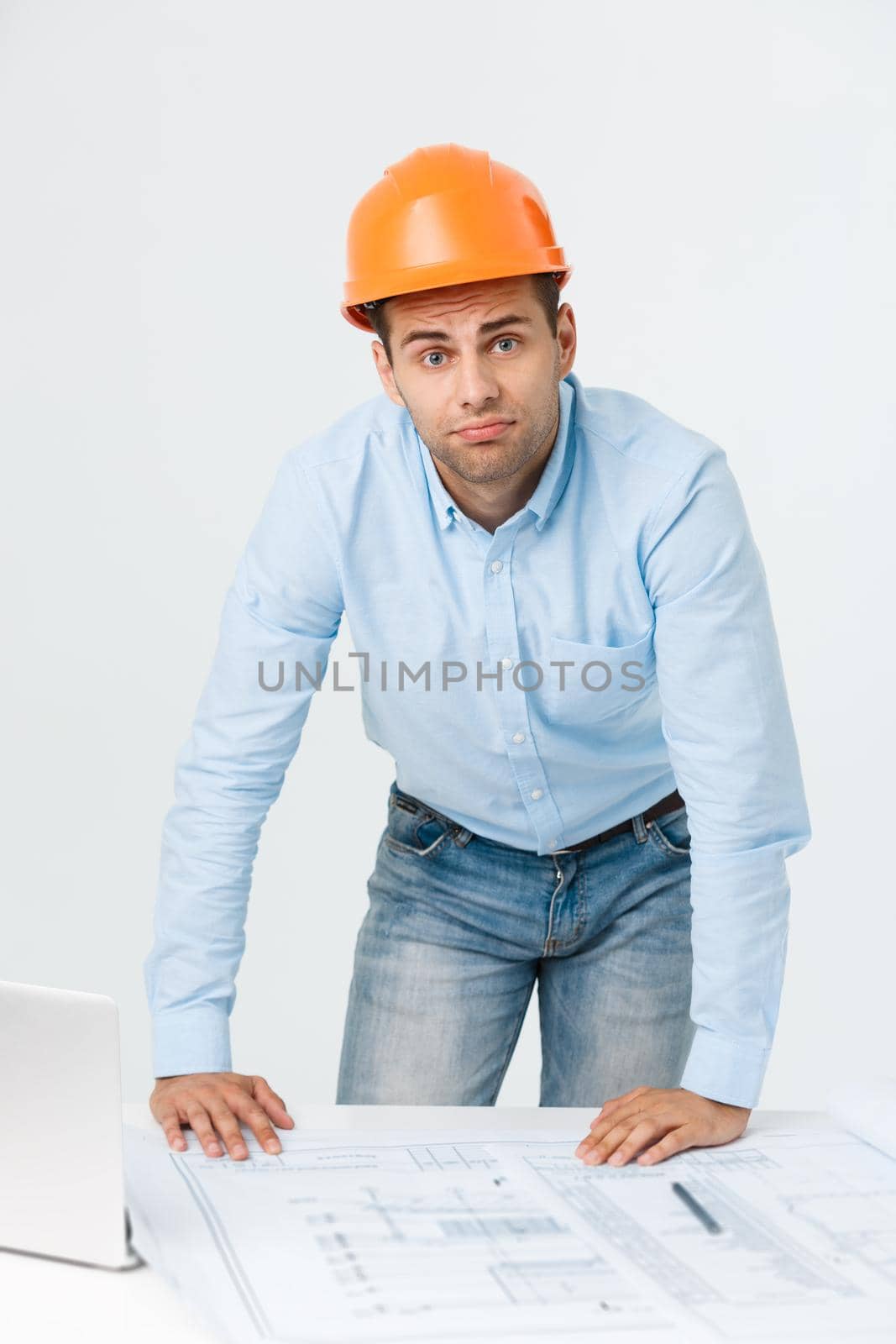 Young workman annoyed angry in furious gesture. Negative expression on white grey background.