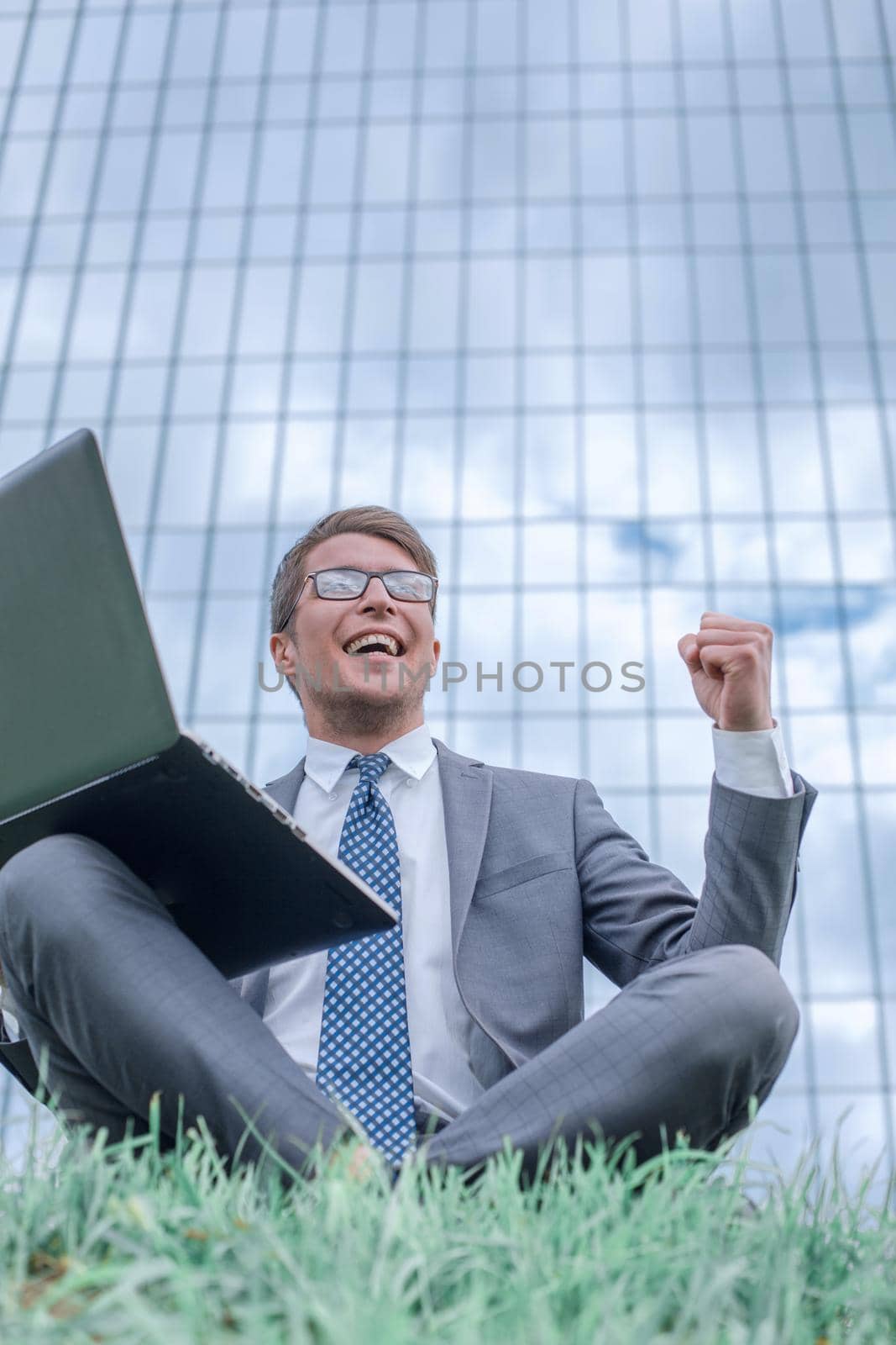 happy businessman looking at his laptop screen by asdf