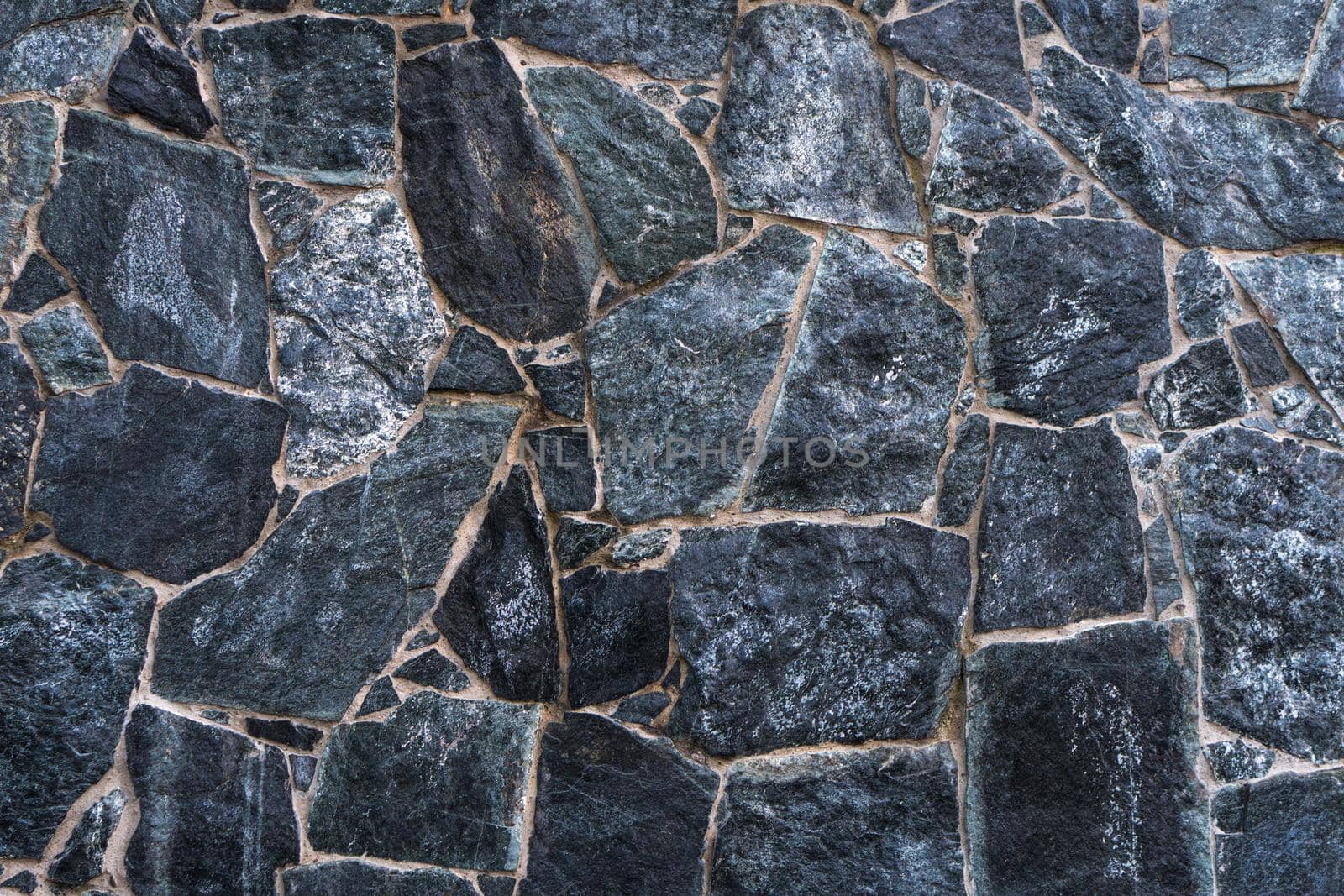 Wall of uneven natural stone, decorative wall, texture background