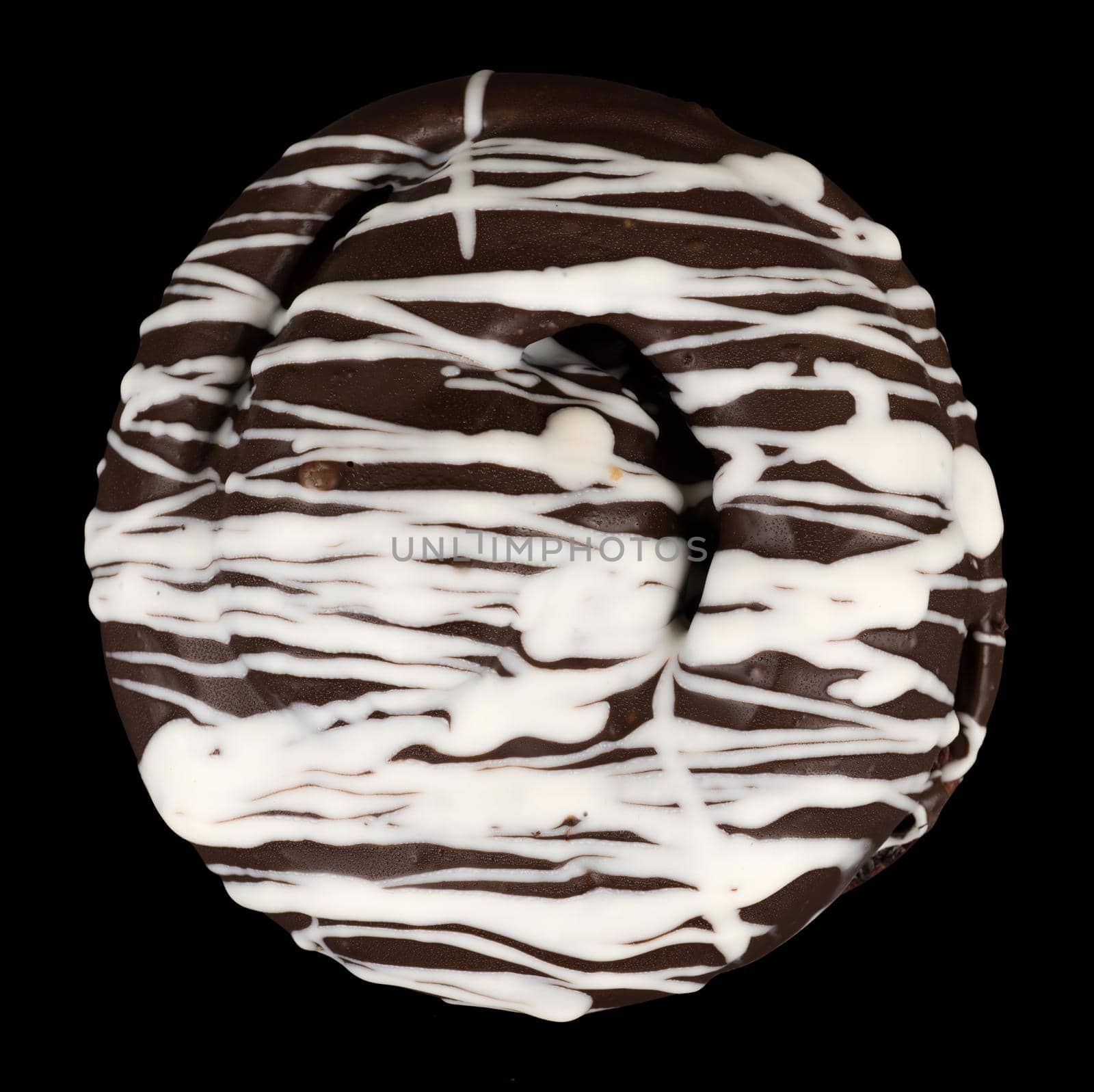 bun covered with chocolate, dark and white, on a black background isolated