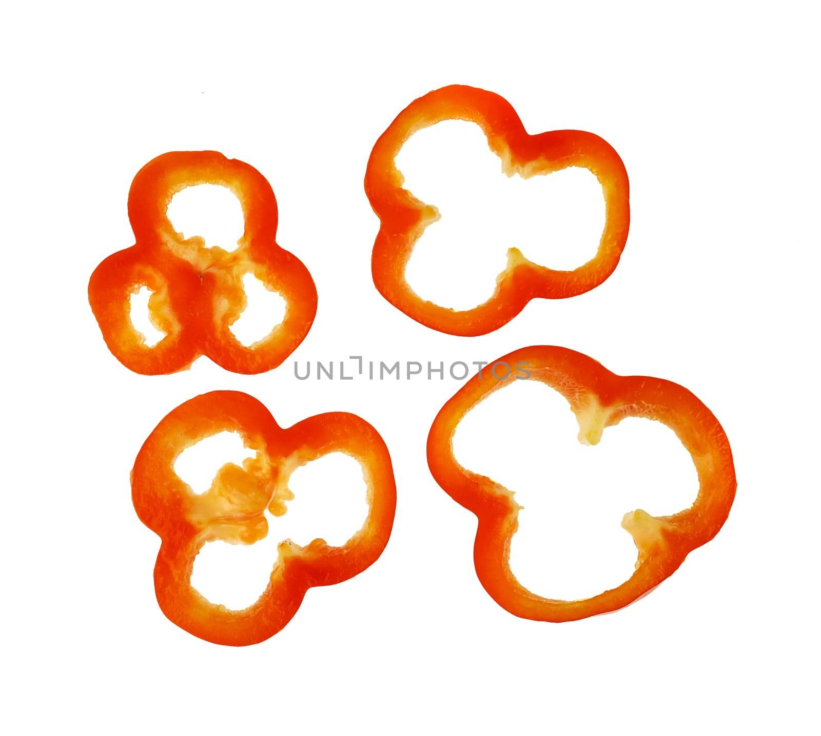 ripe sweet red pepper, cut into pieces, top view on a white background