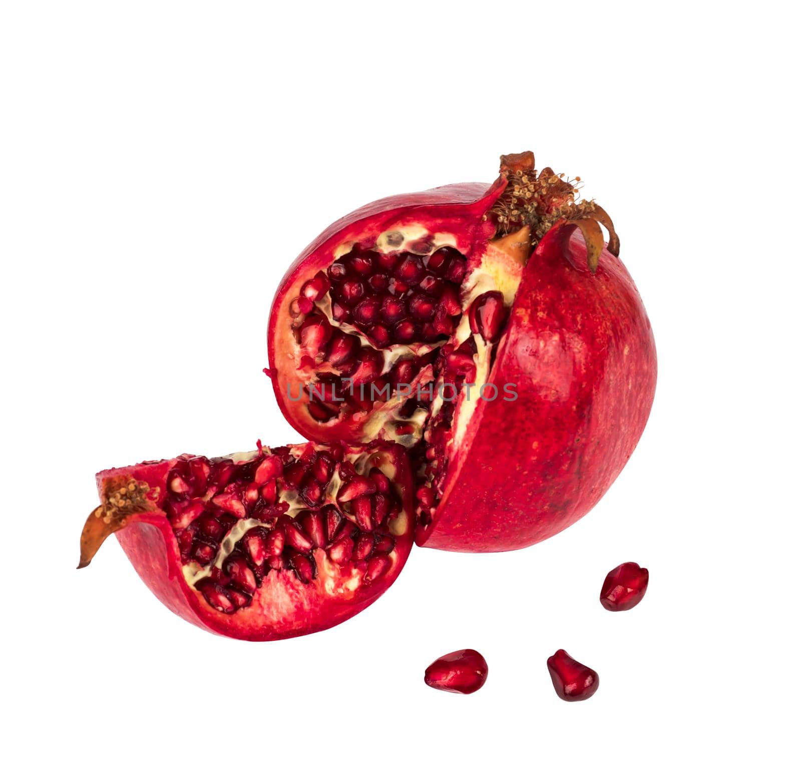 pomegranate cut into pieces and grain separately on a white background