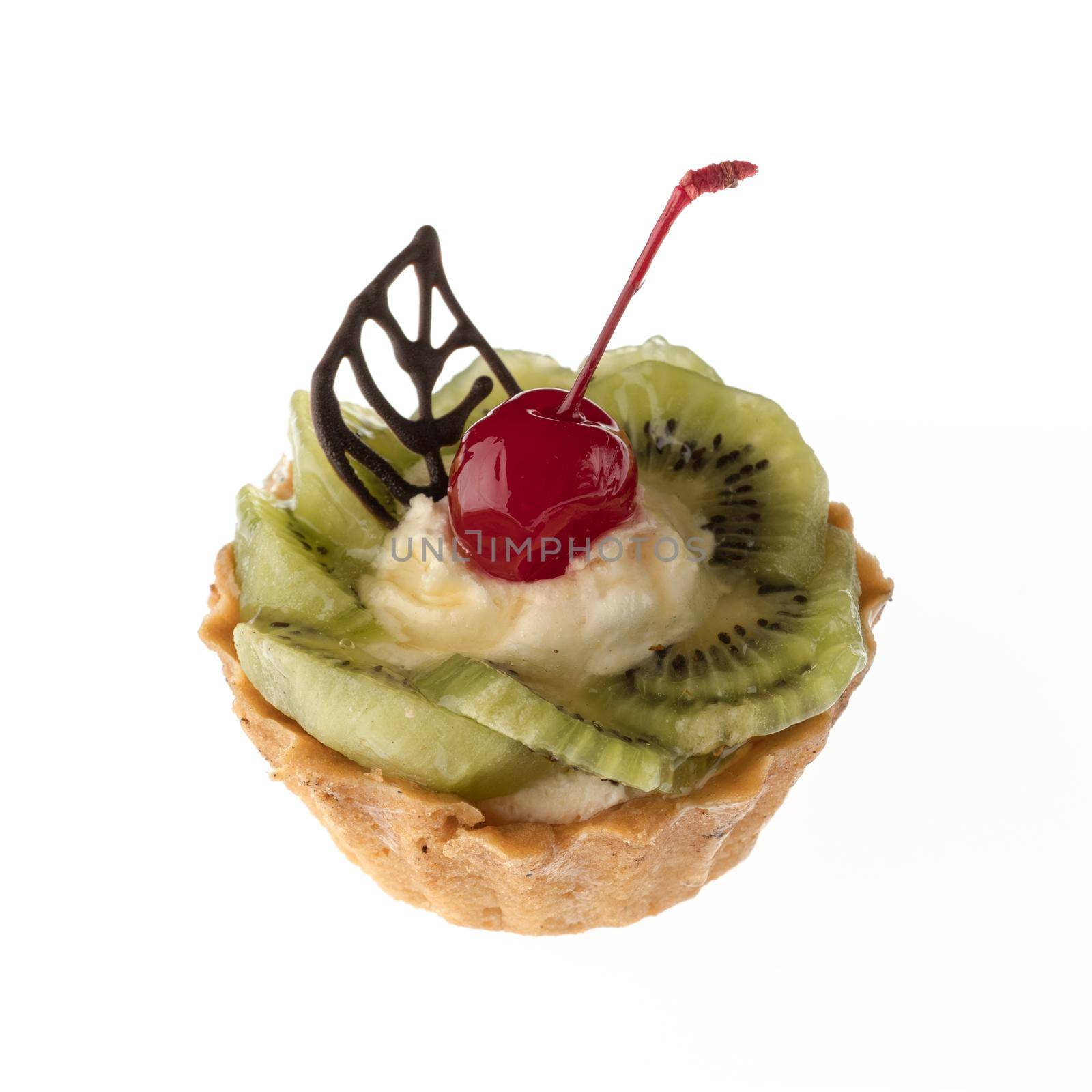 Dessert, cake with kiwi and cherries on a white plate isolated