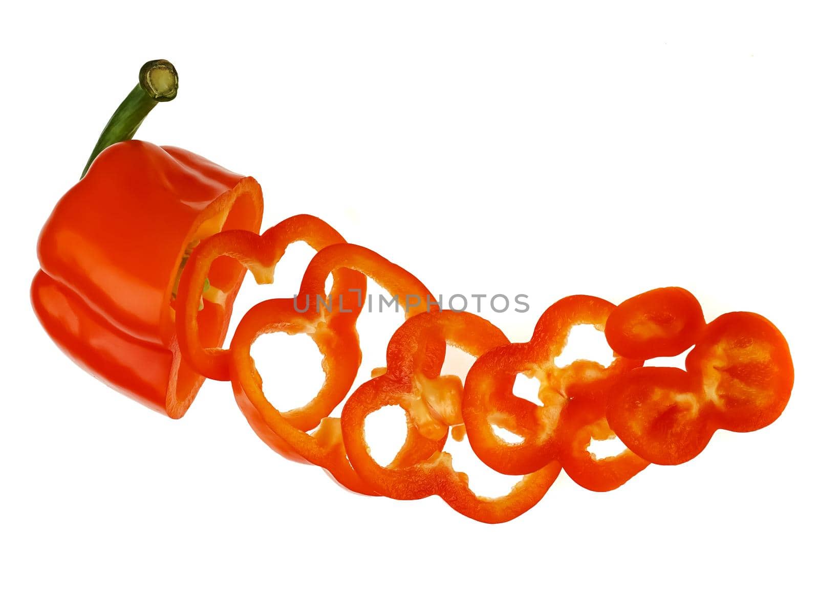 ripe sweet red pepper, cut into pieces, on a white background