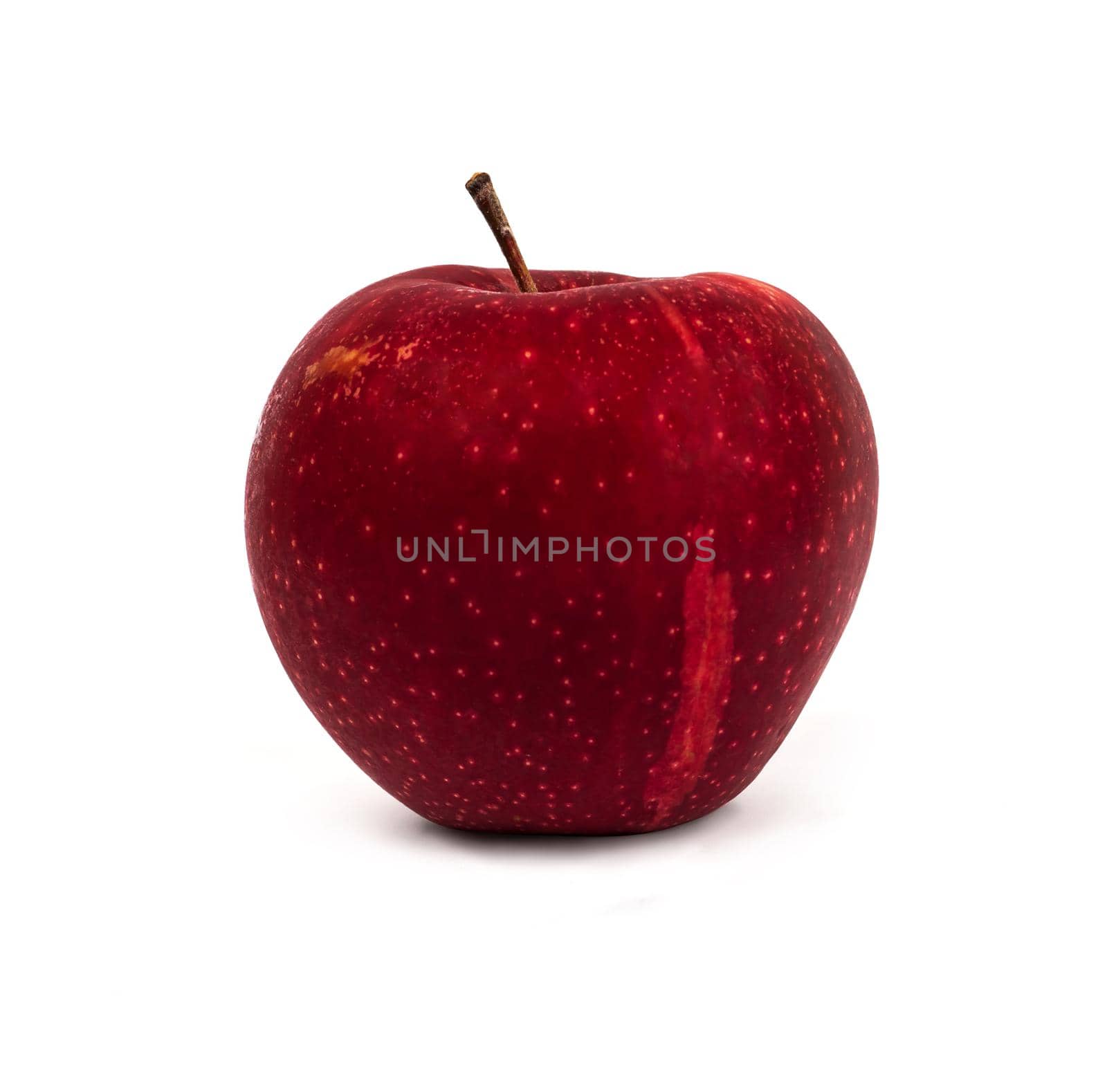 A whole ripe apple, red variety, on a white background with, a shadow