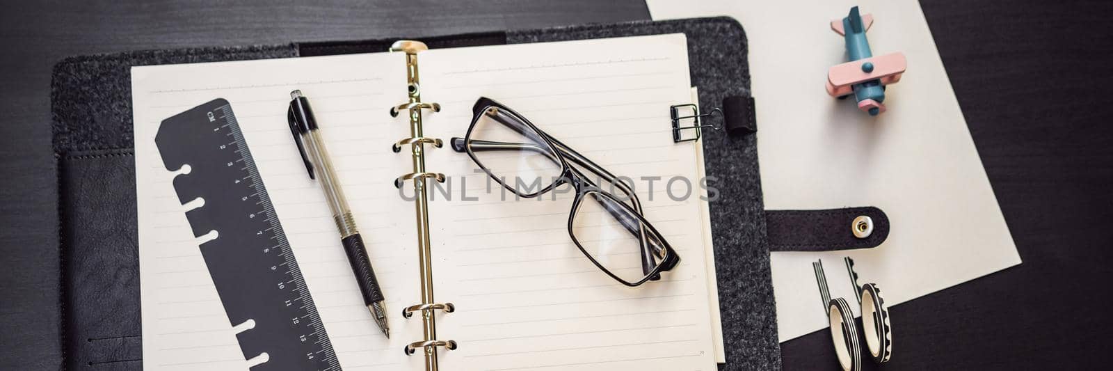 Notepad and stationery on a black background. Planner for business and study. Fans of stationery BANNER, LONG FORMAT by galitskaya