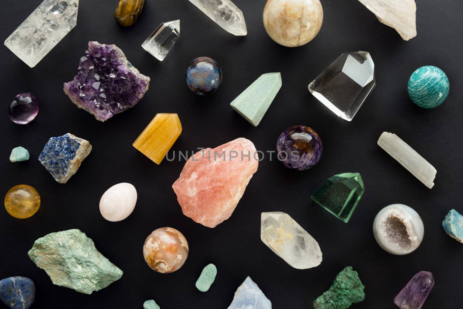 Beautiful crystal stones set on black background. Colorful gemstones and crystals on dark background. Background of healing minerals for relaxation and meditation. Flat lay. Top view