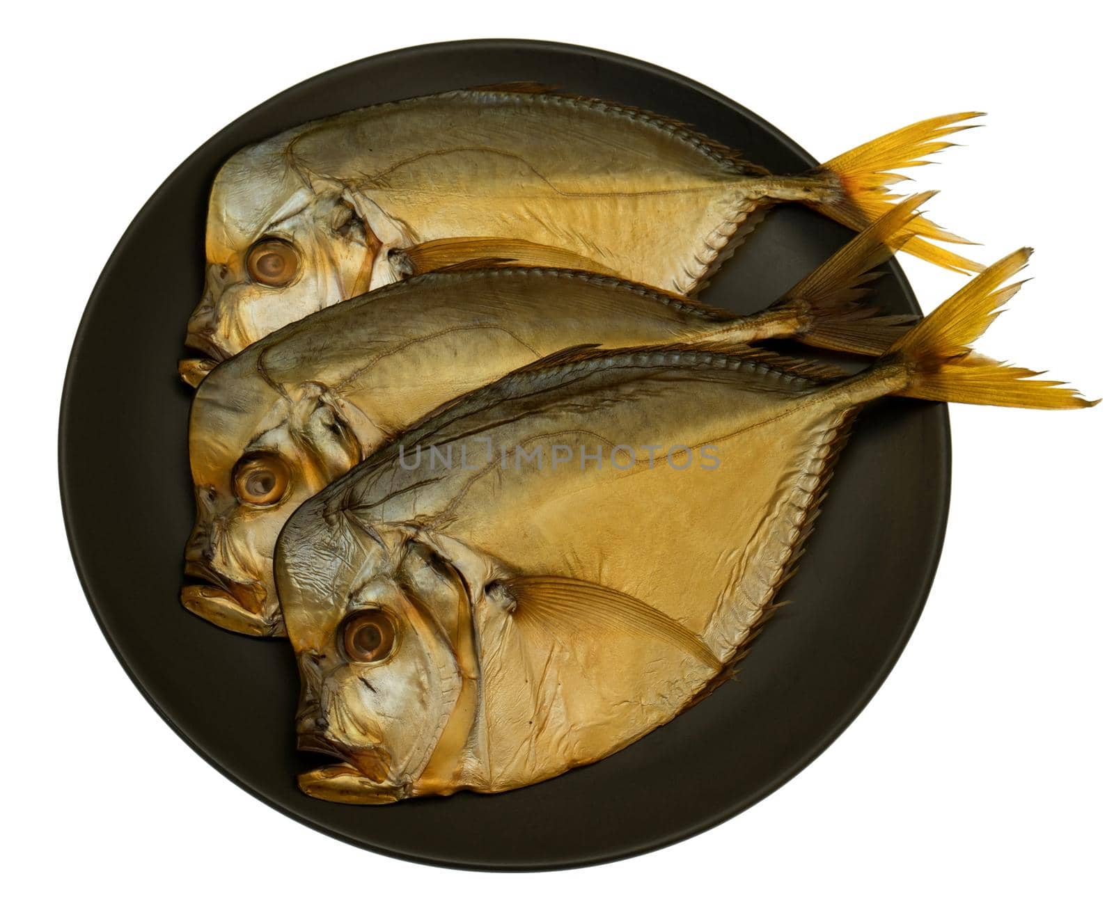 Three smoked vomer fish, on a plate isolated on white